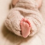 feet-dreamy-child-enveloped-woolen-scarf_1304-4903