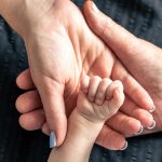 hands-senior-person-little-baby-close-up_169016-36204